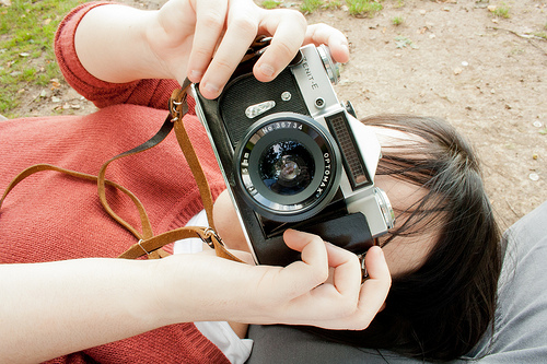 A woman taking a photo with a Zenit E
