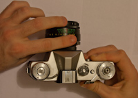 Adjusting the exposure setting on a Zenit E SLR camera